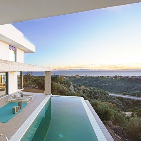 Admire the panoramic sea and town view from the infinity pool