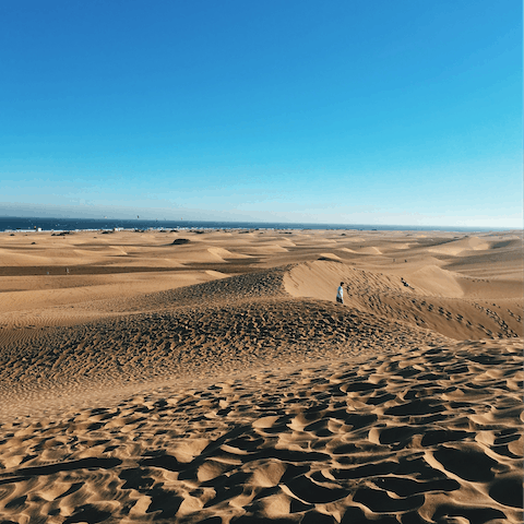 Feel the sand beneath your feet at Maspalomas’ beach and  dunes – just an eight-minute drive away