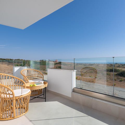 See out to the sparkling sea from your private balcony