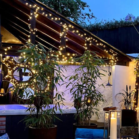 Toast the day from the hot tub surrounded by twinkling lights