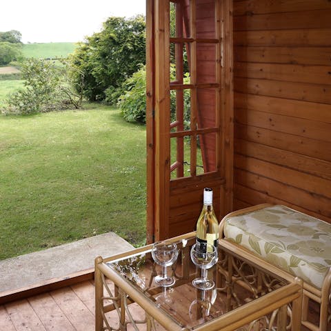 Sip a glass of wine in the summer house and enjoy the country views