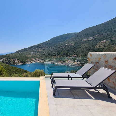 Sunbathe on the luxurious loungers while watching the yachts sail by the Lefkas mountains