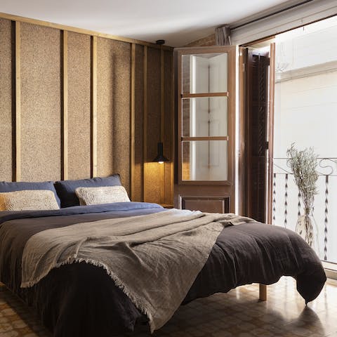 Wake up by the  cork headboard and open the French windows as you sip your morning espresso