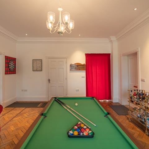 Set up a pool tournament or play some darts in the games room