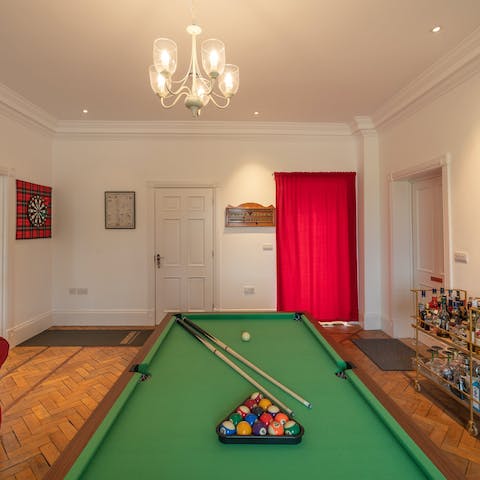 Set up a pool tournament or play some darts in the games room