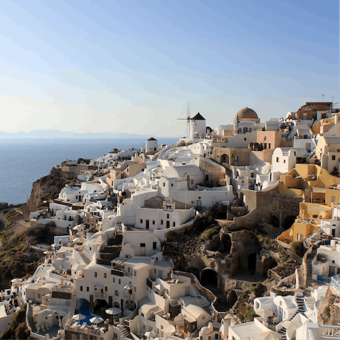 Spend an afternoon exploring the small whitewashed village of Oia