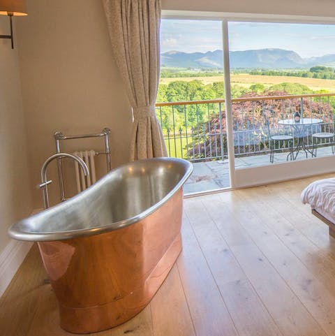 Soak up the views from the master bedroom's copper roll top bath