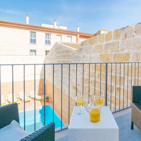 Tuck into breakfast out on your private balcony