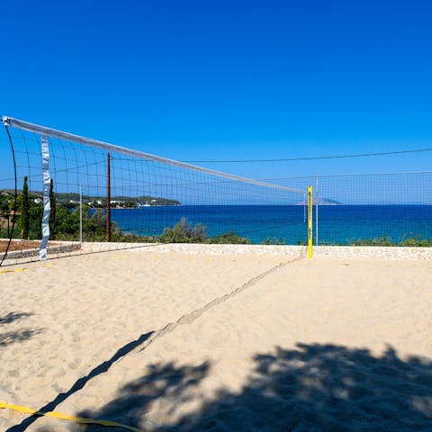 Play beach volleyball against the backdrop of the Aegean Sea
