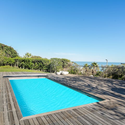 Enjoy a refreshing dip in your private pool with the ocean as your backdrop