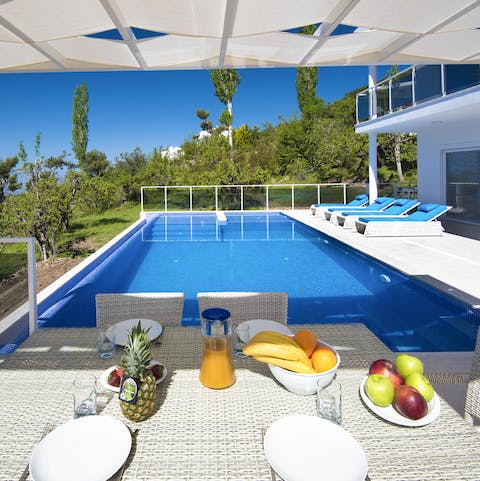Start the day with fresh fruit and pastries on the outdoor dining table