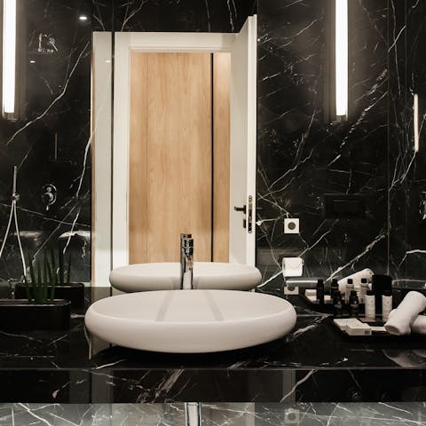 Get ready in the black marble bathroom before an evening out
