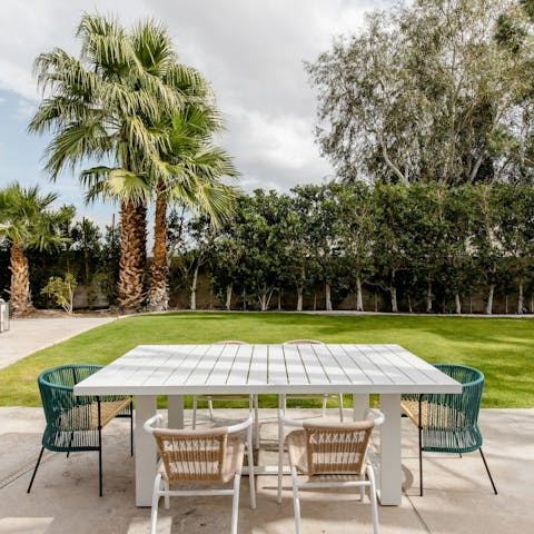 Enjoy an alfresco lunch  in the palm-lined garden-patio area