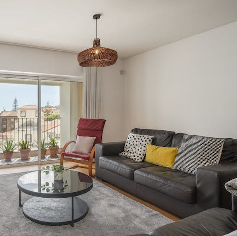 Relax with a glass of Poncha on the squashy leather sofa