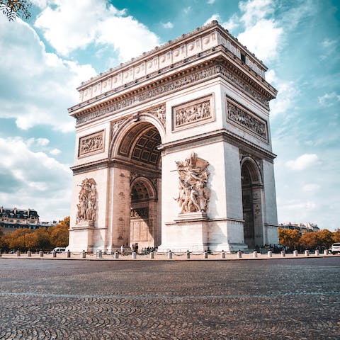 Visit the Arc de Triomphe and the boutiques of the Champs-Élysées nearby