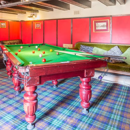 Compete at a game of billiards in the games room