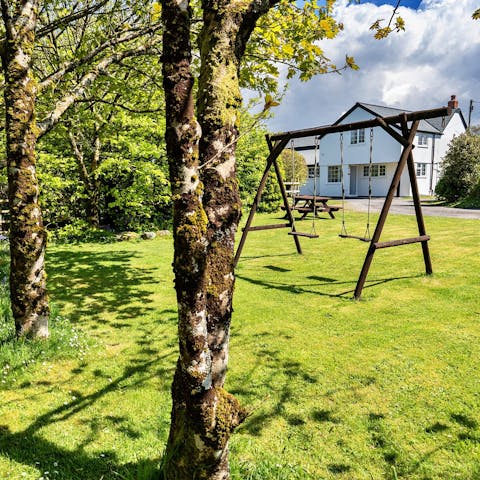 Unwind in the garden as the kids play on the swings