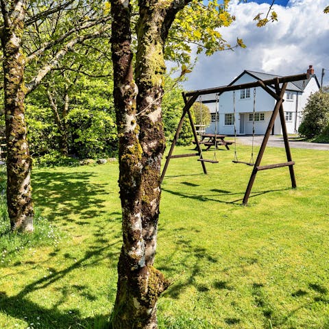 Unwind in the garden as the kids play on the swings 