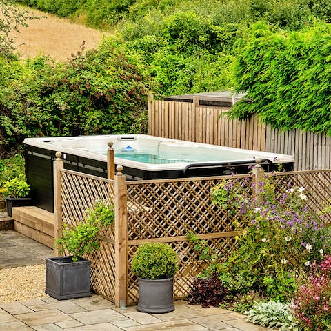 Unwind with a long bubble in the hot tub, admiring the country views