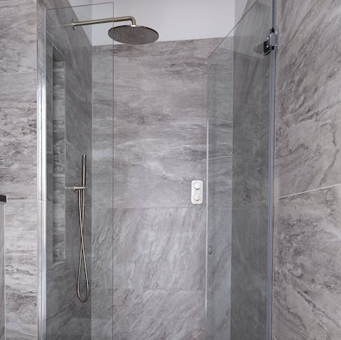Get mornings off to a relaxing start with a soak under the marble-clad rainfall shower