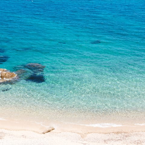 Discover the beautiful coastline of Mykonos – Psarou beach is only a ten–minute drive away