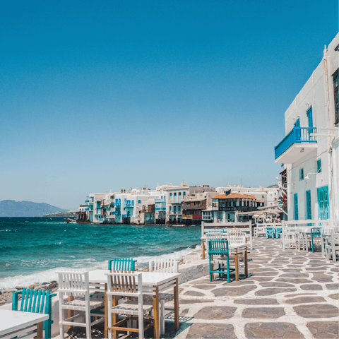 Dine by the waterside in Mykonos Town, a ten-minute drive