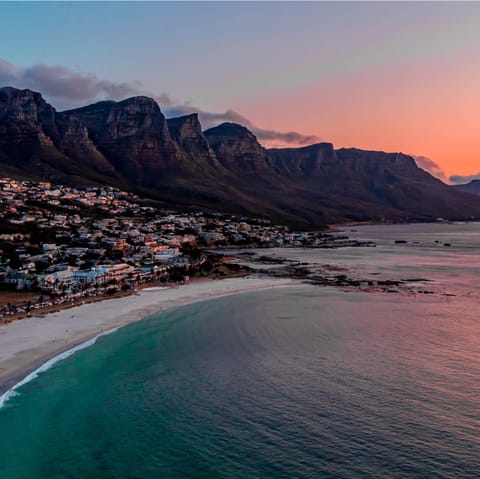 Enjoy a sunset stroll across the sands of Camps Bay Beach nearby