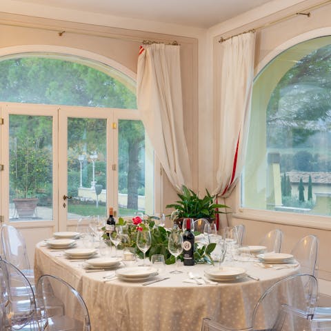 Gather for a formal dinner at the dining table inside, where the view from arched windows is fabulous