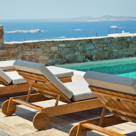 Bag a poolside lounger with a view of the Aegean Sea