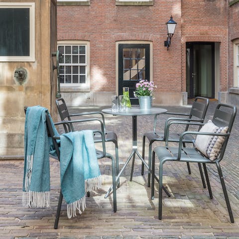 Catch the afternoon sun in the shared courtyard, the perfect spot for a cup of coffee