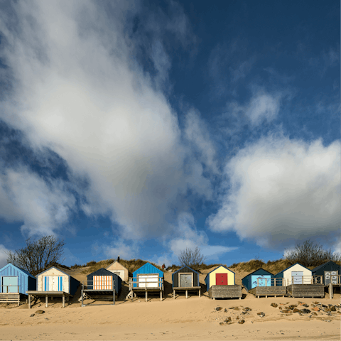 Stroll along the rows of beach huts on the sandy beaches of Abersoch