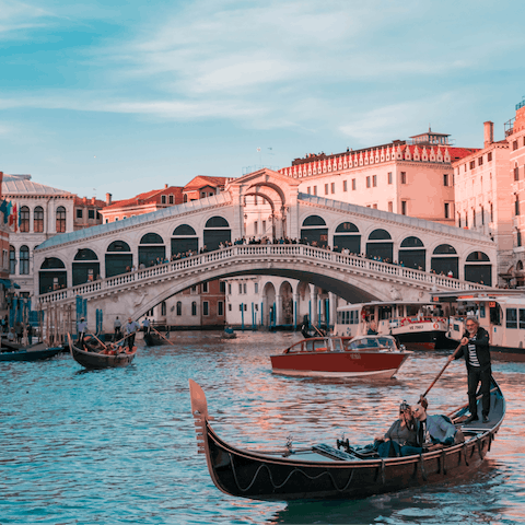 Stroll across the historic Rialto Bridge, a three-minute walk away