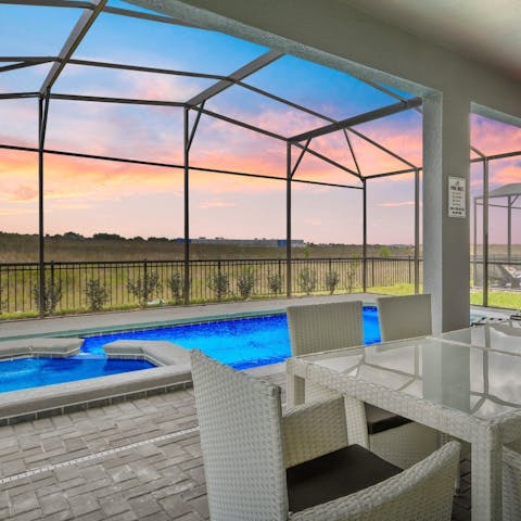 Relax in the private pool and jacuzzi area admiring the sun setting on the horizon 