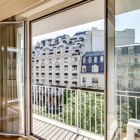Step out onto the balcony and admire the pretty Parisian street