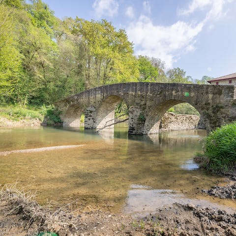Fish for trout in the Lihoury River, in the shade of the medieval bridge