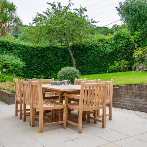 Enjoy hearty breakfasts and coffees around the outdoor dining table, surrounded by lush greenery