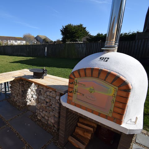 Show off your culinary skills with the outdoor pizza oven and barbecue