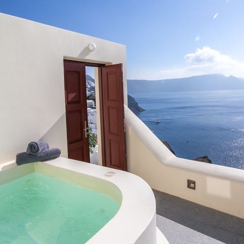 Enjoy a long soak in the hot tub with views across the glistening Aegean