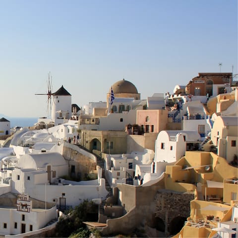 Wind your way through the streets of Oia, stopping to admire the views and stunning architecture