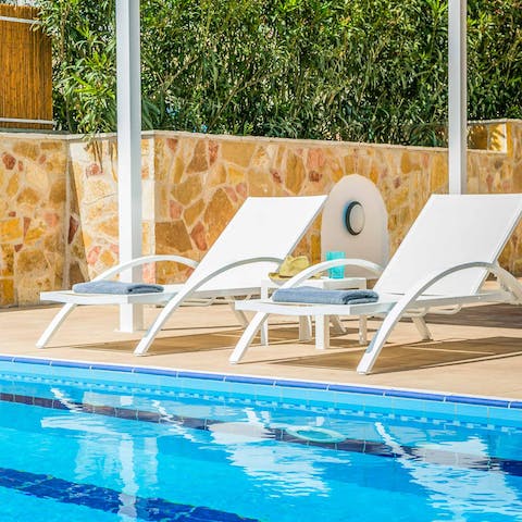 Stretch out on the poolside loungers for a sunbathing session