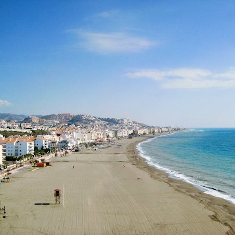 Make the fifteen-minute walk to the soft sand of Torre de Benagalbón beach