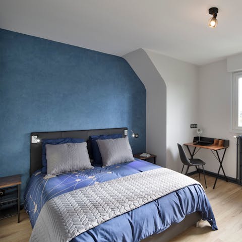 Sleep soundly in the calming blue bedroom after a busy day