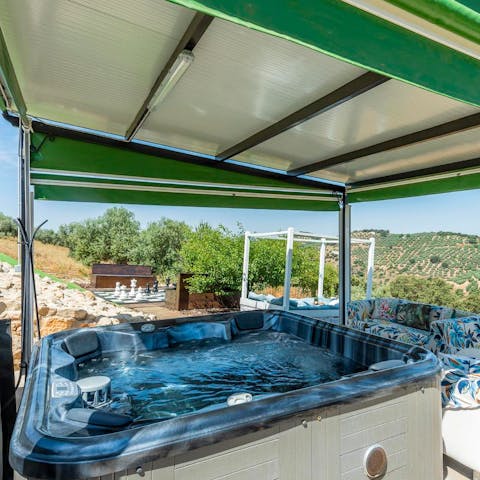 Relax in the private Jacuzzi with views of the Spanish hills