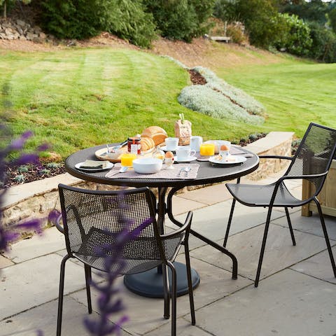 Enjoy a leisurely breakfast on the patio overlooking the garden
