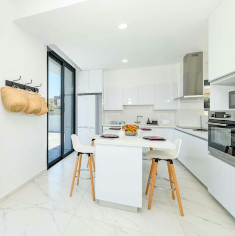 Share coffee and a light breakfast around the sleek kitchen island