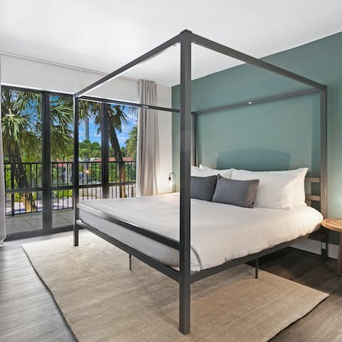Get some rest in the four-poster bed with its views of swaying palms