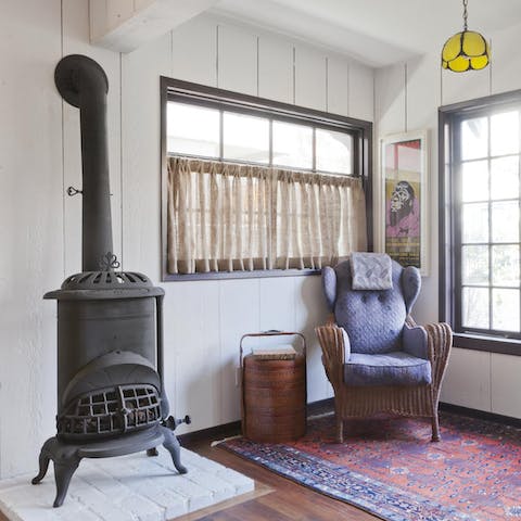 Take a seat by the fire and read a book by the natural light streaming in through the window