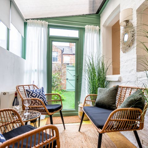 Take a load off in the conservatory – we think it's the perfect spot to enjoy a glass of wine and a good book