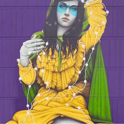 Admire the building's mural, painted by local artist Fin Dac