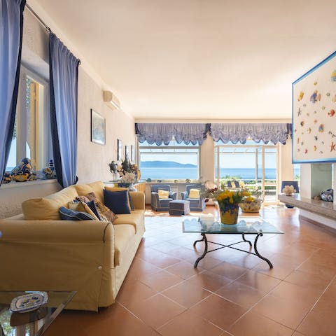 Spread out across the huge living room with a view of the water